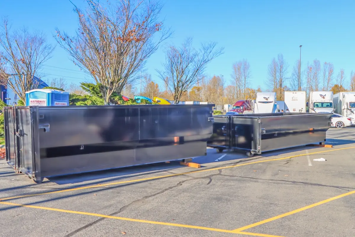 Professional dumpster rental service with roll-off container on residential driveway in Lake Barcroft